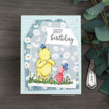 Daisy-print card with Pooh and Piglet under a 'Happy Birthday' banner.