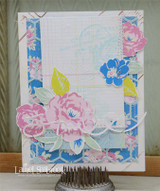 Card with a ledger paper panel lightly stamped with the French labels, layered with pink and blue die-cut roses on a floral frame.