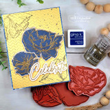 Yellow embossed card with navy and gold layered poppies and a white die-cut script word reading Celebrate.