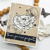 Kraft card with black outline poppies, white splatter and a black strip reading To me, you are perfect, with metal butterflies alongside.