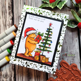 Holly-print framed card with markers alongside: Pooh trims a colorful tree beneath “A Christmas wish from me to you.”