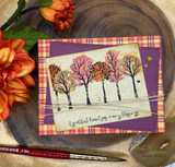 Autumn tree grove on a purple-and-plaid card, 'a grateful heart sees many blessings'.