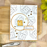 Card with an outlined beer mug pattern stamped in grey, one mug colored gold inside a copper circle beside a 'cheers' label.
