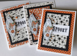 Three spooky-print cards of ghosts on bat and spider patterned papers.