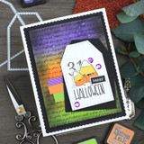 A spooky gift tag with a candy-corn ghost over the Halloween script background in purple and green — 'happy Halloween.'