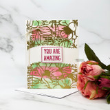 Stenciled pink and green card with 'YOU ARE AMAZING' over the floral texture