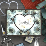 Card with soft-gray asters framing a heart and 'thankful for you.'