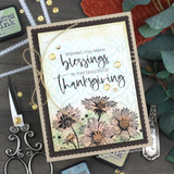 Card with a colored aster bunch and 'Wishing you many blessings in this season of thanksgiving.'
