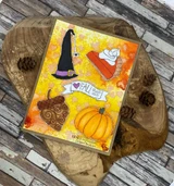 Orange and yellow ink-blended card with a black witch hat, a pie slice, a brown acorn, an orange pumpkin and a 'FALL that's all' banner