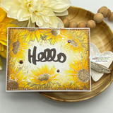 Angie Blom's lush sunflower border framing a card edge to edge, a red rubber background stamp shown on a bright fall card.