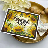 Angie Blom's lush sunflower border framing a card edge to edge, a red rubber background stamp shown on a bright fall card.