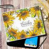 Angie Blom's lush sunflower border framing a card edge to edge, a red rubber background stamp shown on a bright fall card.