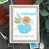 Kraft card with a white stitched panel holding an aqua pumpkin with an orange sunflower and green leaves, a blue happy birthday label and a warm wishes line beneath.