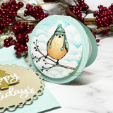 Card with the coloured bird on a branch over clouds with holiday berries.