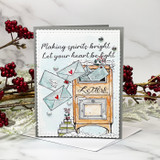 Card with envelopes and an orange mailbox, 'Making spirits bright, Let your heart be light.'