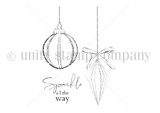 Red rubber stamp sheet with two hanging Christmas ornaments, one round and ribbed, one faceted teardrop tied with a bow, above a script sentiment reading 'Sparkle all the way'.