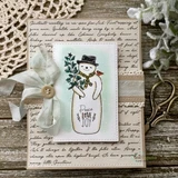 Vintage-style holiday card with a snowman holding a pine branch, a cream script-text background, lace ribbon and a button