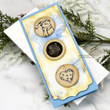 Slimline card with a yellow and blue watercolor wash and three kraft circles: the snowman's face, 'Hello, Winter' and the heart ornament.