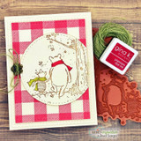 Card with Pooh and Piglet from behind on a red gingham circle with green twine.