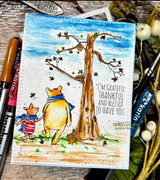 Bright watercolor card with Pooh and Piglet under a blue-sky tree and the grateful sentiment.