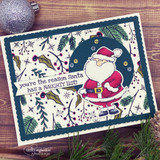 Navy framed card with the holly and pine background hand colored in green and plum, surrounding a Santa in a dark circle.