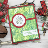 Red card with a green blended panel stamped all over with the pine and berry background, centered on a stamped ornament circle.