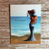The beach woman in a blue gown against an ocean-and-sand scene with 'live carefree.'