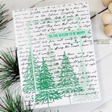 White card with the script background and two green stamped pine trees, lettered ''tis the season to be merry.'