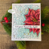 Warm card with red poinsettias and holly berries on the script background, lettered 'Let your heart be light.'