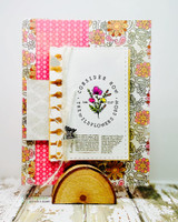 Card with the 'Consider how the wildflowers grow' sentiment over vintage floral papers.