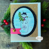 Navy oval-framed card of the snowman on a snowy blue background with red berries