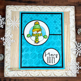 Bright turquoise card with white snowflakes: the snowman peeking through a circle beside a second circle stamped “stay COZY.”