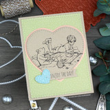 Soft green card with the Pooh picnic scene inside a stitched heart, 'enjoy the day.'