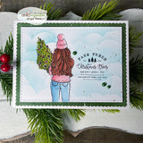 Soft blue card of the girl carrying the tree with 'FARM FRESH Christmas Trees.'