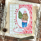 Red-and-cream card of the girl with the tree and 'Merry Christmas.'