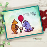 Teal-framed card with Pooh, Piglet and Eeyore colored in classic gold, pink and violet with a red balloon, over 'HAPPIEST OF BIRTHDAYS to you.'