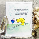 Card of Pooh and Piglet on a green-and-blue watercolor snow scene framed by a stitched border.