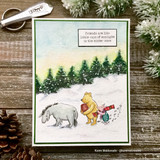 Pooh, Eeyore and Piglet walking a snowy hill with evergreens and the friendship sentiment.
