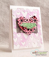 Pink card with the paw-print heart stamped on a tag over embossed hearts, with a quote about the privilege of being loved by a dog.