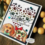 Jewel-toned paw heart card with two puppies wearing heart glasses, 'love is a four-legged word!'