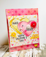 Card with three overlapping hearts coloured pink, coral and yellow on a dotted panel with buttons, sentiments "HUGS & KISSES" and "HAPPY VALENTINE'S DAY."