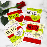 Four small cards in red, green and yellow with tiny word hearts printed across them, each with a "HELLO" or "HAPPY VALENTINE'S DAY" heart, beside a red rose.