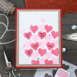 Card with a cascade of pink ombre hearts stamped through the stencil, topped with love word stamps.