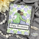 Purple hearts stencil background behind a couple embracing with a 'Happy Anniversary' sentiment on the sample.