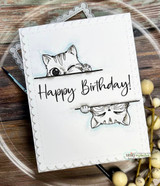 Scalloped card with two cats peeking over lines, one from above and one snoozing below, around 'Happy Birthday!'