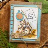 Sample card with the napping cat colored ginger on a mustard blanket beside a coloured coffee cup, layered on aqua notebook paper and kraft with lace, twine and a wooden button, stamped 'it's ok to take a break'.