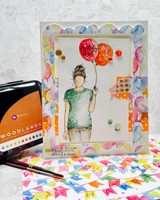 Mixed-media card of the girl with a red balloon.