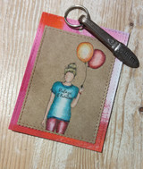 Kraft card of the girl holding balloons with 'Vintage & Fabulous.'