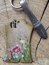 Kraft tag with the wildflower meadow and foxes softly colored.
