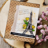 Airmail-themed card of the Eiffel Tower with "love is a language spoken by the heart."